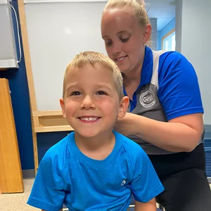 Chiropractor Mt Vernon OH Devin Daniels Adjusting Happy Pediatric Patient